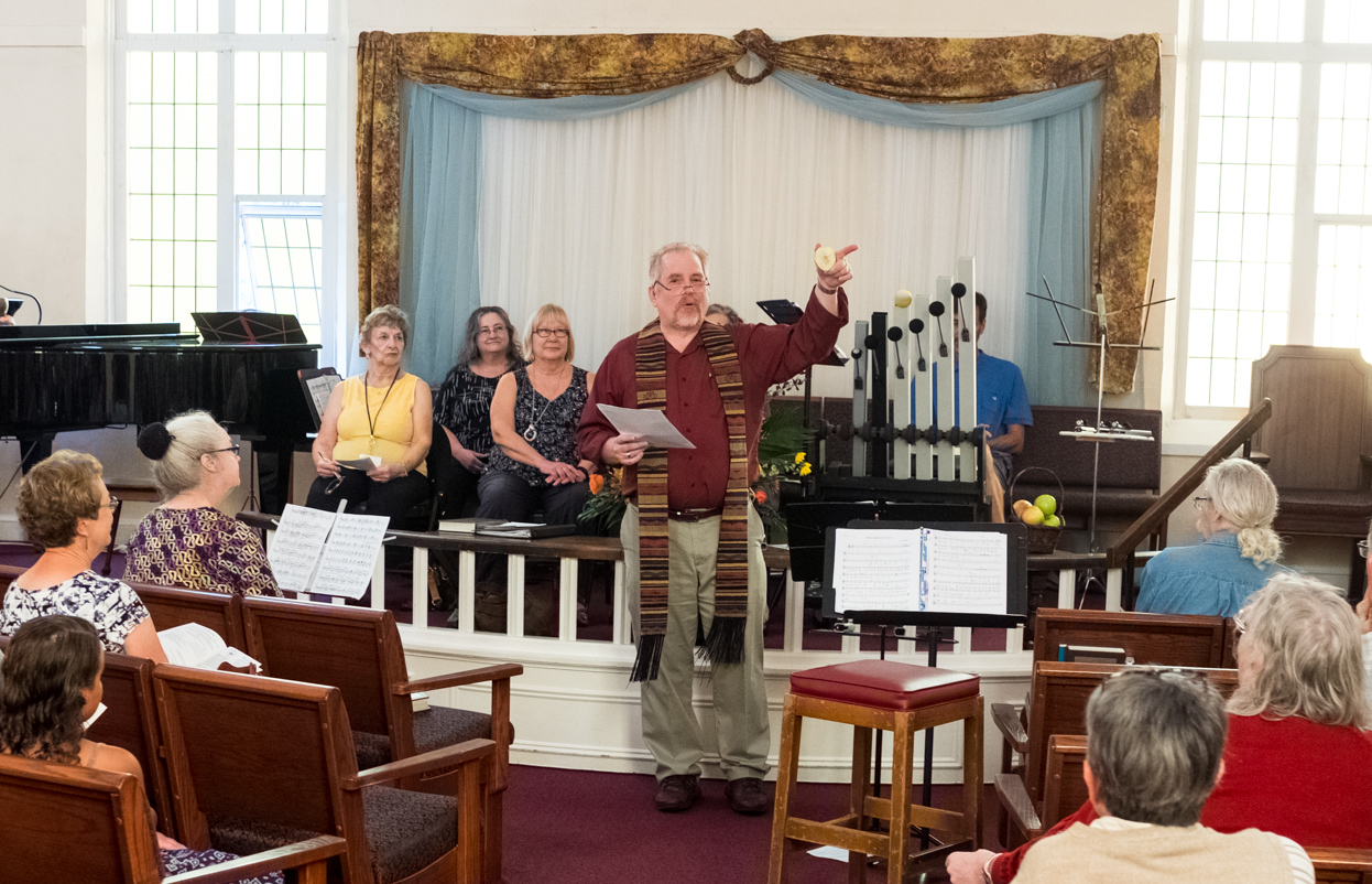 Example Worship Service: Apple Ceremony 2018. Reverend Steven Protzman at the front of the church, delivering a sermon.  