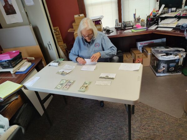 Marion Yeagler (a former Financial Secretary) assists in counting the collection.